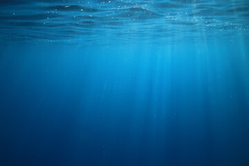 ocean underwater rays of light background, under blue water sunlight - obrazy, fototapety, plakaty