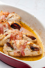 chicken rolls stuffed with dry tomatoes in bacon