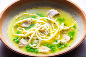 chicken broth with green peas and noodles