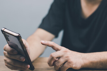 technology concept social media man using smart phon access online media Through the Internet, there is marketing to answer customer chats. by working at home