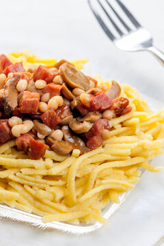 spatzles with bacon, beans and mushroom sauce