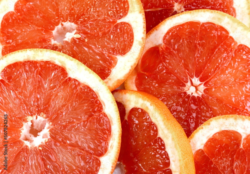 Wall mural top view of grapefruit slice, as background. macro of red grapefruit. fruit citrus grapefruit textur