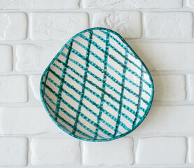 Mid-century modern pottery - white wall plate with green web pattern