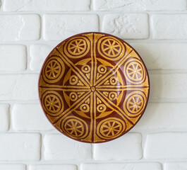 Mid-century modern pottery - brown wall plate with folk art pattern
