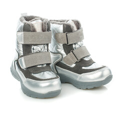 Close up of children's warm down boots for a girl of silver color isolated on a white background.