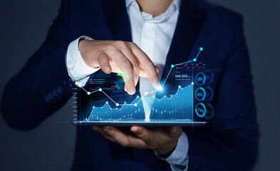 Business person  analysing growing virtual hologram of statistics, graph and chart. Investment of growth on currency rate.Business strategy development and growing growth plan.
