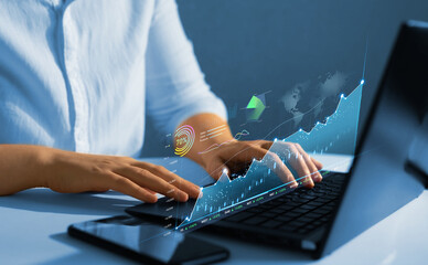 Fototapeta na wymiar Person analysing economic growth graph financial data on laptop. Stock market investment. Financial and banking Technology. Business strategy and digital marketing concept.