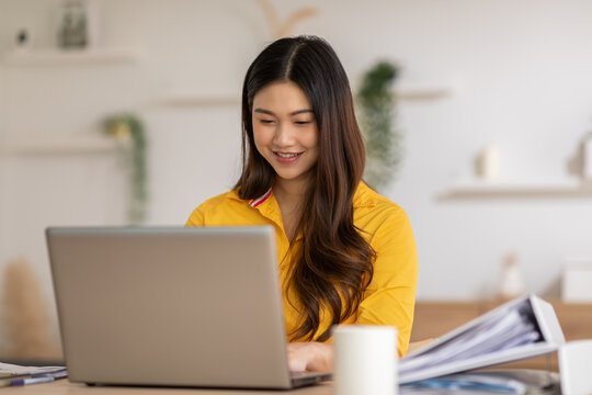 Entrepreneur Beautiful Business Asian Young Woman Wear Yellow Shirt Work Online With Laptop At Home.Freelance Female Working Online Sale Marketing At Home.Small Business Startup Concept