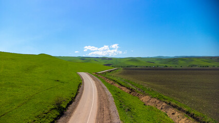 Top view from a drone on mountain pastures and road