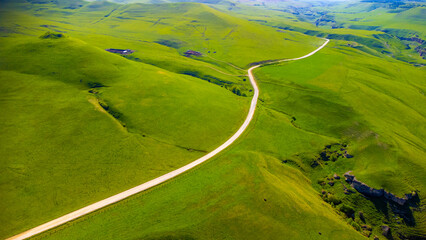 Top view from a drone on mountain pastures and road © Тамара Ульбашева