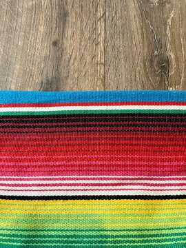poncho serape Mexican background for Mexico cinco de mayo fiesta wooden copy space stripe pattern minimalist simple Mexican background backdrop - stock photo,