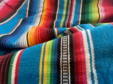blanket poncho Mexican serape background for Mexico cinco de mayo fiesta wooden copy space stripe pattern minimalist simple Mexican background backdrop - stock photo,