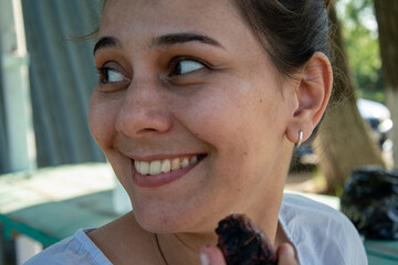 Girl eats barbecue in summer picnics, family vacation, woman