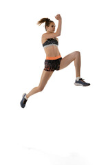 Long jump technique. Studio shot of professional female athlete in sports uniform jumping isolated on white background. Concept of sport, action, motion, speed.