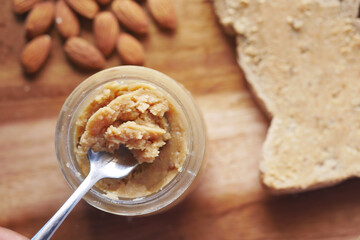 almond butter spread on a brown bread on table 