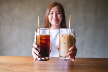 Blurred of a young woman holding and serving two glasses of iced coffee