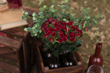 Bouquet of red roses in a wooden box. For a catalog or online store. Floral shop concept. Beautiful freshly cut bouquet. flower delivery