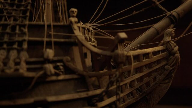 Panning along antique ship deck to mast.