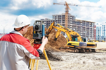 Surveyor engineer is measuring level on construction site. Surveyors ensure precise measurements...
