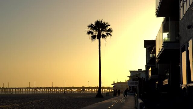 Man roller skating and dancing in Newport Beach at sunset