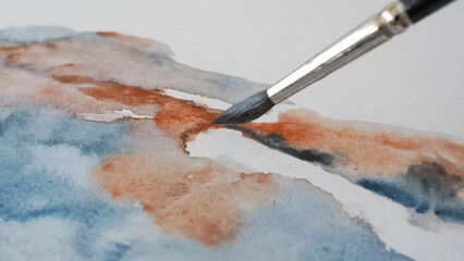 Brush spreading watercolor paint on paper, close up - Powered by Adobe