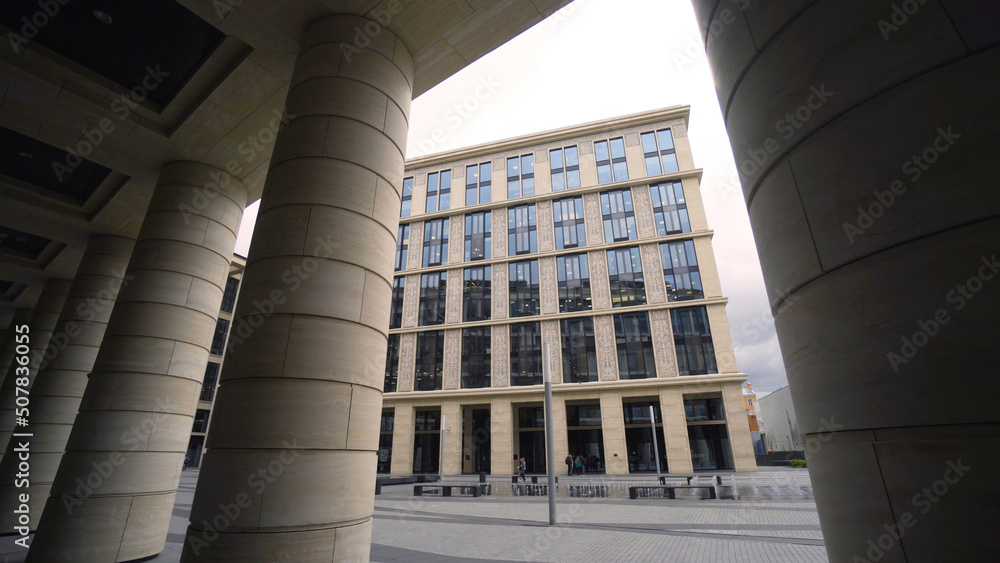 Poster beautiful colonnade of modern business building. action. external corridor with rows of columns of b