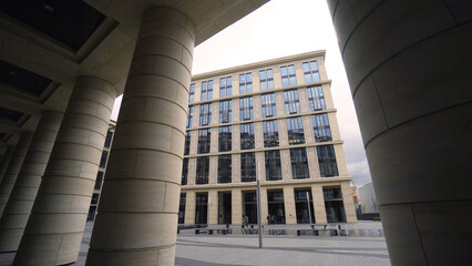 Beautiful colonnade of modern business building. Action. External corridor with rows of columns of business center. Ancient solutions in architecture of modern buildings