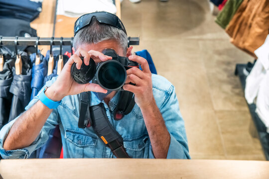 Photographer taking pictures inside a fashion shop