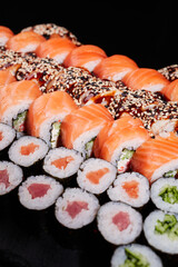 Close up of sushi set with lots of sushi rolls Philadelphia and maki rolls.