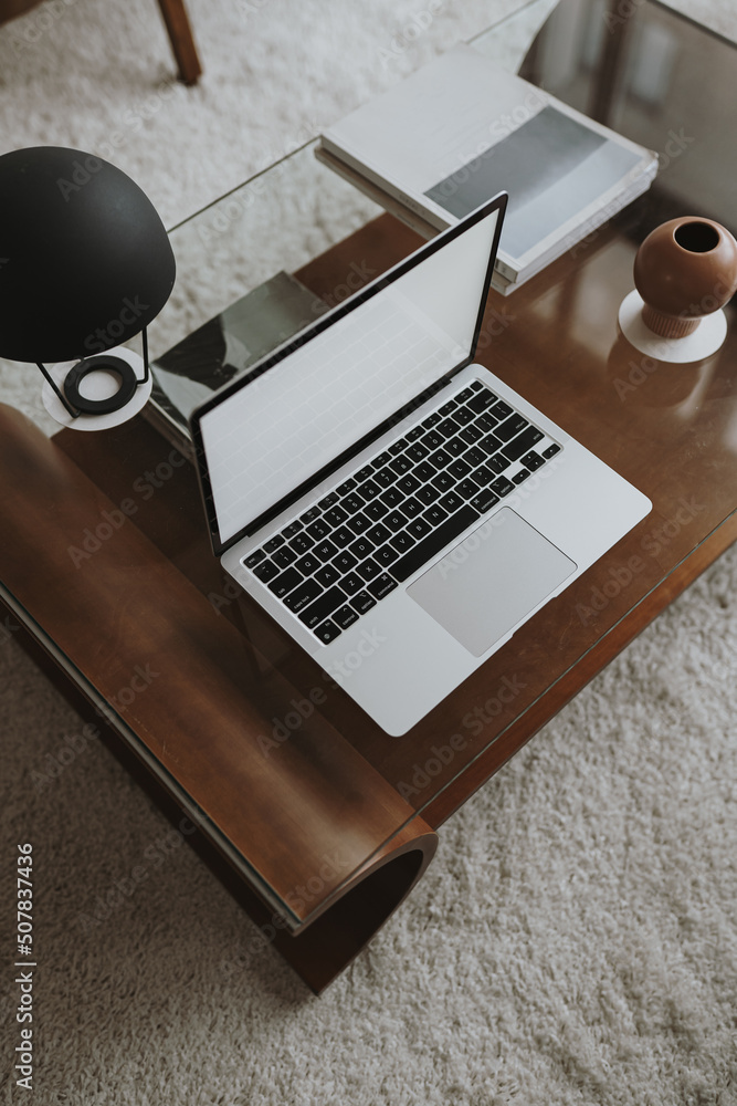 Wall mural laptop computer with blank screen on wooden table with lamp. aesthetic influencer styled workspace i