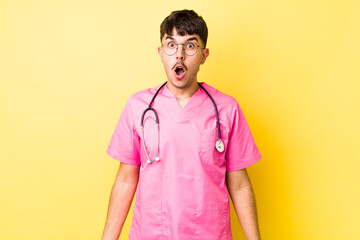 young hispanic man looking very shocked or surprised. veterinarian concept