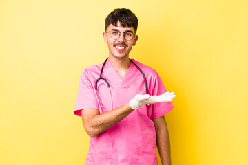 young hispanic man smiling cheerfully, feeling happy and showing a concept. veterinarian concept - obrazy, fototapety, plakaty