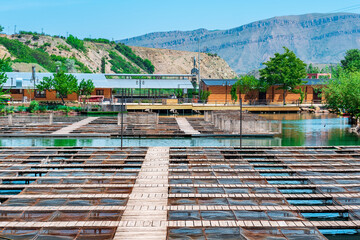fish farm with commercial fishing and a fish restaurant on a river in a mountain valley