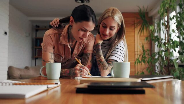 Lesbian couple showing affection and working