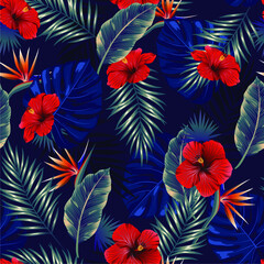 Fototapeta na wymiar Seamless pattern of tropical dark leaves of palm trees and hibiscus on a blue background. Design for paper, cover, fabric, interior decor and other users.