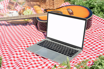 closeup of picnic place andlaptop with blank screen for mockup