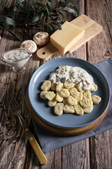 Cooked traditional Italian gnocchi dish with creamy mushroom sauce and cheese
