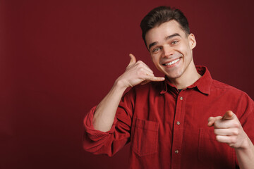 Young white man gesturing and pointing finger at camera