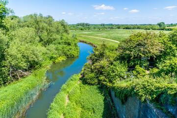Fototapeta na wymiar A view looking down from the top of the Iron Trunk aqueduct for the Grand Union canal at Wolverton, UK in summertime