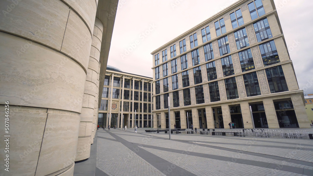 Poster beautiful colonnade of modern business building. action. external corridor with rows of columns of b