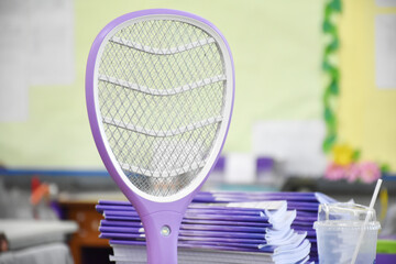 Electronic mosquito swatter in the office room for killing mosquitoes and insects inside the...