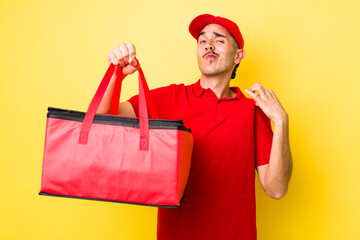 young hispanic man looking arrogant, successful, positive and proud. delivery pizza concept