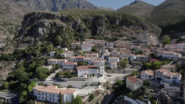 drone video passing the village of Nje Muaj, Spile, Sen in Himare, on the Albanian coast, laSh8, until reaching the mountains. The shot is from low flight at the height of the houses.