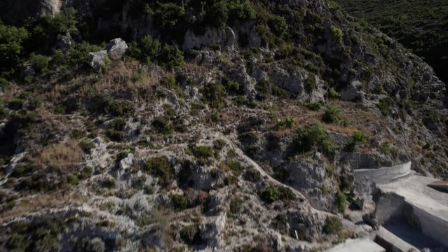 Drone video passing the village of Nje Muaj, Spile, Sen in Himare, on the Albanian coast, laSh8, until reaching the mountains. The shot is from low flight at the height of the houses.