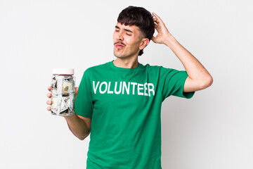 hispanic volunteer feeling puzzled and confused, scratching head. donations concept
