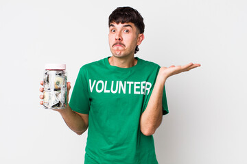 hispanic volunteer feeling puzzled and confused and doubting. donations concept