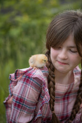 Photo of a village girl with a small chicken.