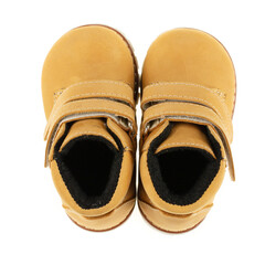 Top view of yellow leather boots for little baby girls on a white background.