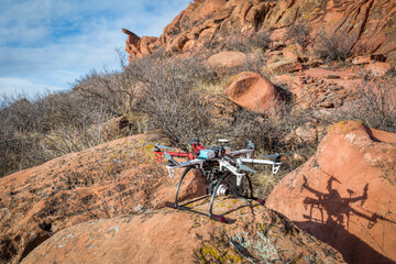 home made hexacopter drone with a small camera in a  sandstone canyon ready to take off