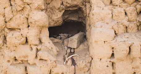 Hole with offering in ancient mud brick wall, Lima Peru